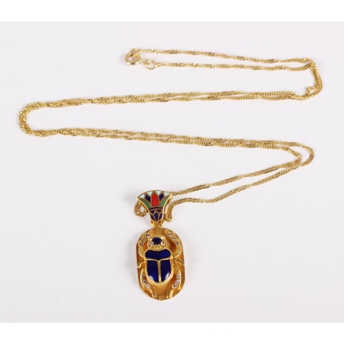 313 - A yellow metal fine link chain, stamped 750, and an Egyptian yellow metal enamel and diamond pendant... 