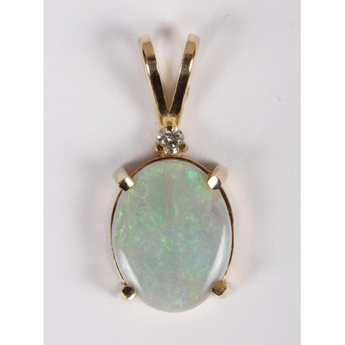 316 - A diamond and opal pendant mounted in yellow metal, stamped 14k