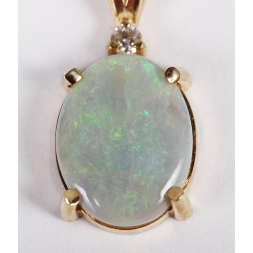 316 - A diamond and opal pendant mounted in yellow metal, stamped 14k