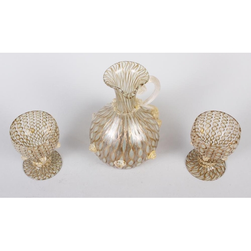 43 - A pair of Venetian gold and clear glass aventurine goblets and a matching jug, 6 3/4