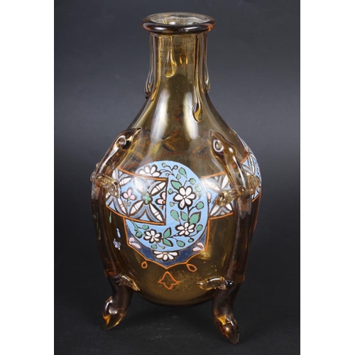 48 - An amber glass and enamel decorated decanter, on three supports COLLECT