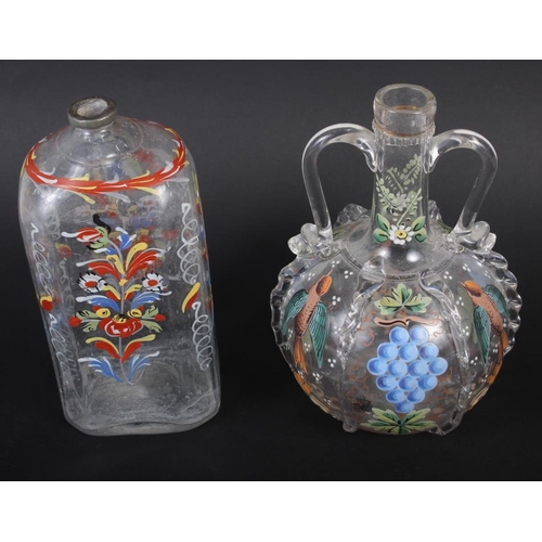 49 - A 19th century glass bottle with carrying handles and enamelled bird and fruit decoration, 6 1/4