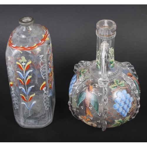 49 - A 19th century glass bottle with carrying handles and enamelled bird and fruit decoration, 6 1/4