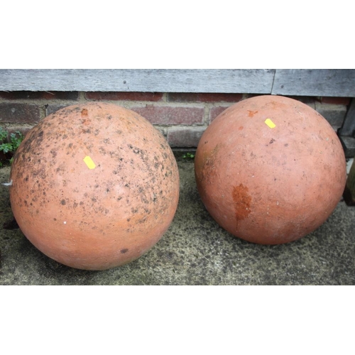 634 - Two ornamental terracotta garden balls, 13 1/2