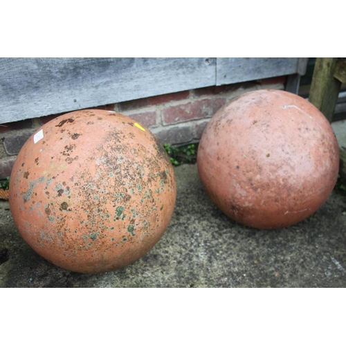 635 - Two ornamental terracotta garden balls, 13 1/2