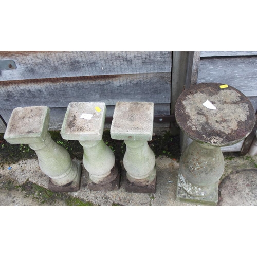 636 - Three cast stone turned columns, on square bases, 18 3/4