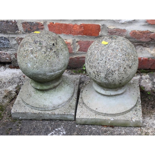 638 - A pair of cast stone garden finials, on square bases, 12