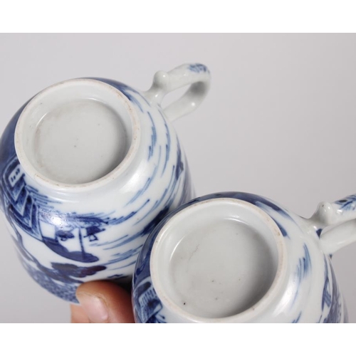 85 - Two Chinese blue and white coffee cups, decorated buildings in a landscape (hairline crack to one) C... 