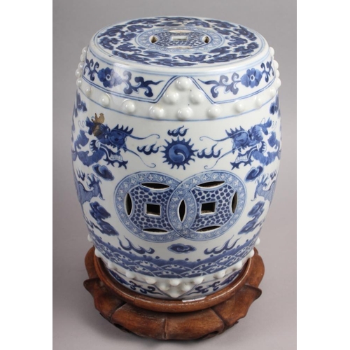 93 - A pair of Chinese blue and white miniature garden seats, decorated dragons and clouds, on hardwood s... 