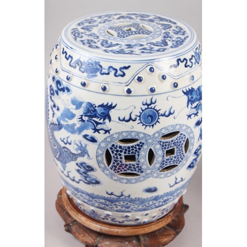 93 - A pair of Chinese blue and white miniature garden seats, decorated dragons and clouds, on hardwood s... 