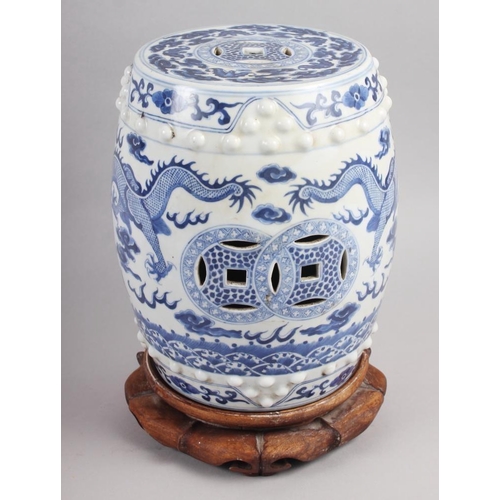 93 - A pair of Chinese blue and white miniature garden seats, decorated dragons and clouds, on hardwood s... 