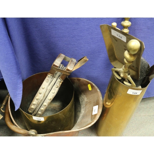 128 - A copper coal helmet, two brass shell cases, a set of brass fire implements and a pair of bellows