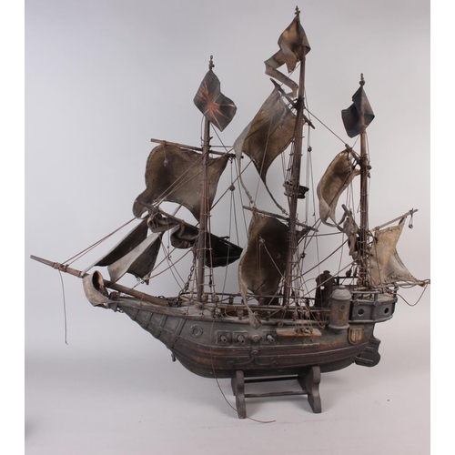 142 - A painted wood model of a galleon, 35