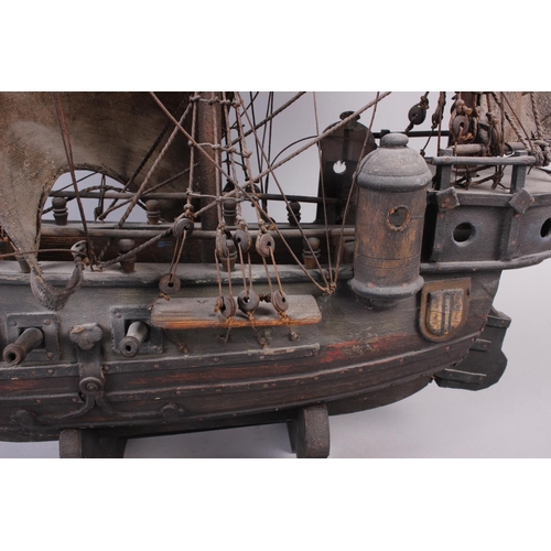 142 - A painted wood model of a galleon, 35