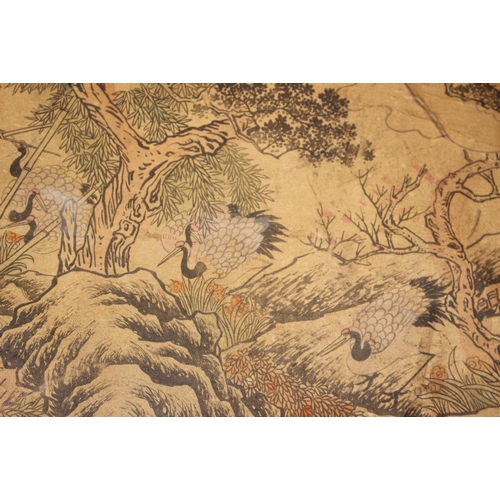 103 - A Chinese scroll of storks in a panoramic landscape of trees and rocks, 178 3/4