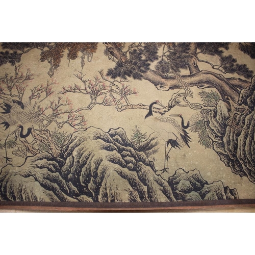 103 - A Chinese scroll of storks in a panoramic landscape of trees and rocks, 178 3/4