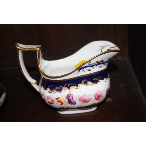 26 - A Daniels type floral gilt decorated cream jug and a blue and floral panel decorated milk jug