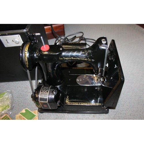 111 - An early 20th century Singer sewing machine, in mahogany dome top case, and an electric Singer sewin... 