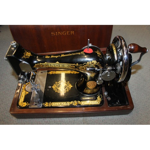 111 - An early 20th century Singer sewing machine, in mahogany dome top case, and an electric Singer sewin... 