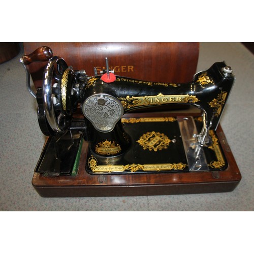 111 - An early 20th century Singer sewing machine, in mahogany dome top case, and an electric Singer sewin... 