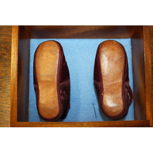 163 - An infant's pair of silk and embroidered shoes, in display case, 7 1/4