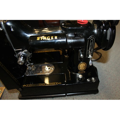 112 - A Singer electric sewing machine, Model 222K, Serial No EL683476, in fitted case with accessories, a... 