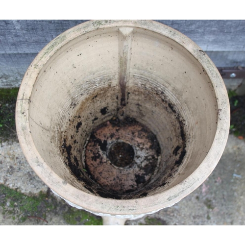 587 - A ceramic water purifier with relief decoration (damages), and a moulded glass carboy, 20 1/2