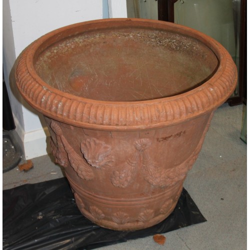 580 - A terracotta planter with swagged decoration, 28