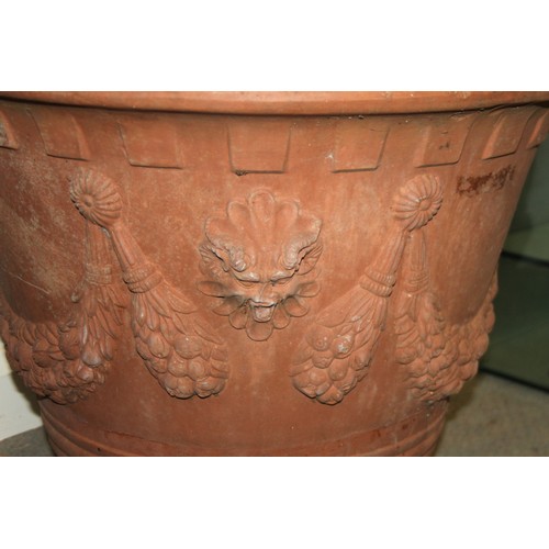 580 - A terracotta planter with swagged decoration, 28