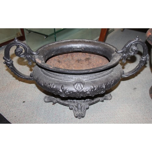 581 - A cast iron oval two-handle planter, 24