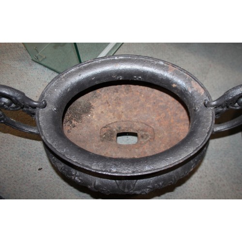 581 - A cast iron oval two-handle planter, 24