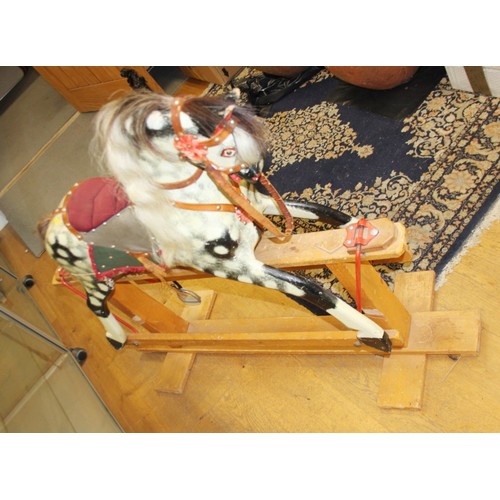 152 - A mid 20th century carved and painted wood rocking horse, 46 1/2