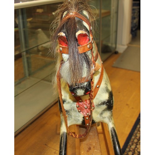 152 - A mid 20th century carved and painted wood rocking horse, 46 1/2