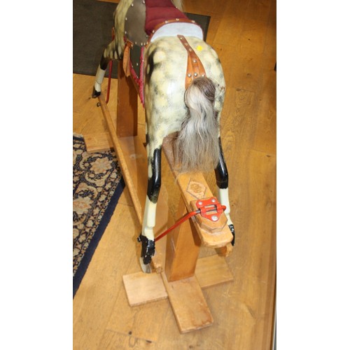 152 - A mid 20th century carved and painted wood rocking horse, 46 1/2