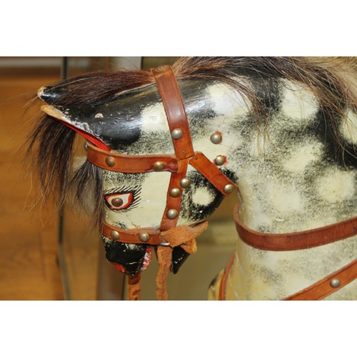 152 - A mid 20th century carved and painted wood rocking horse, 46 1/2