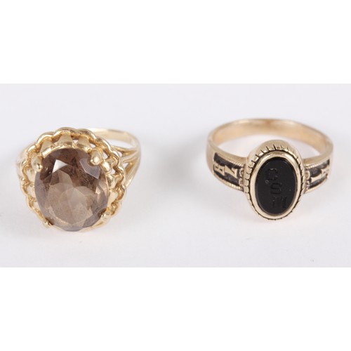 307 - A yellow metal and onyx ring, stamped 10k, size K, and a yellow metal and smokey quartz ring, stampe... 