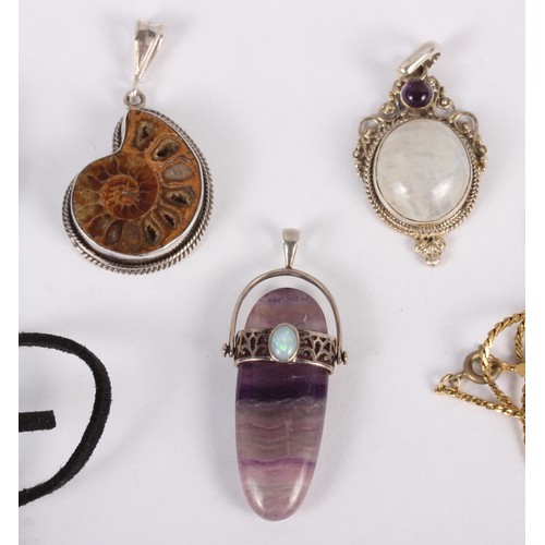 308 - A white metal amethyst colour and opal pendant, stamped 925, a similar ammonite pendant and three ot... 