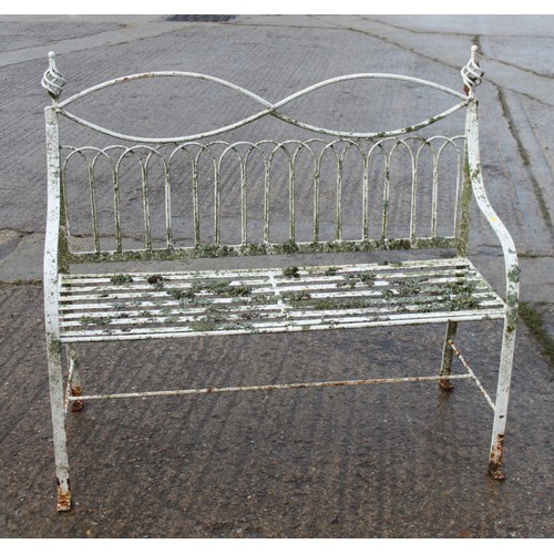 588 - A wrought iron garden settle of Edwardian design with slatted seat, 45