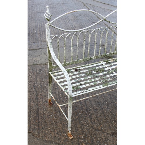 588 - A wrought iron garden settle of Edwardian design with slatted seat, 45