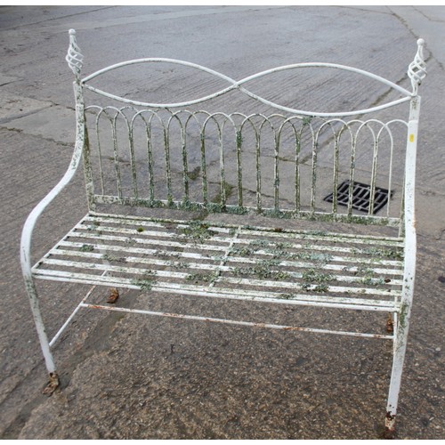 589 - A wrought iron garden settle of Edwardian design with slatted seat, 45