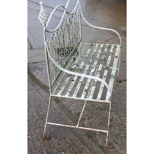 589 - A wrought iron garden settle of Edwardian design with slatted seat, 45