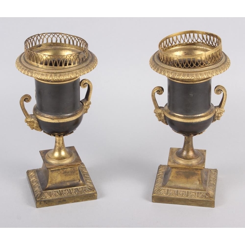 125 - A pair of Regency gilt bronze campana urns with relief figure decoration and satyr mask handles 8 1/... 