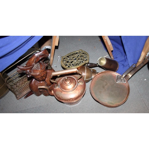 126 - A copper kettle, a saucepan and cover, a magazine rack and an Indonesian carved figure