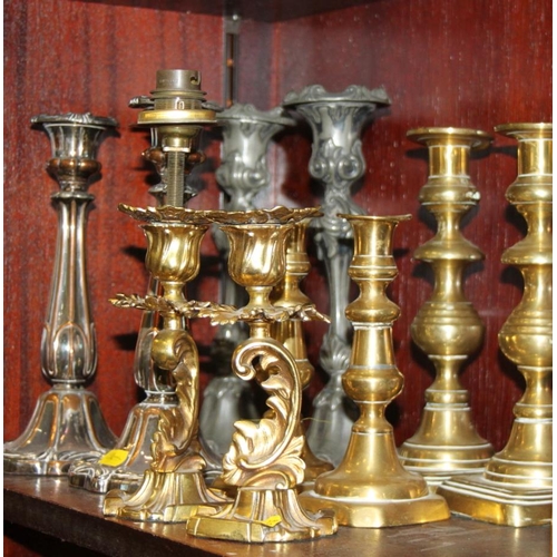 130 - A pair of ornate gilt candlesticks, 9 1/4