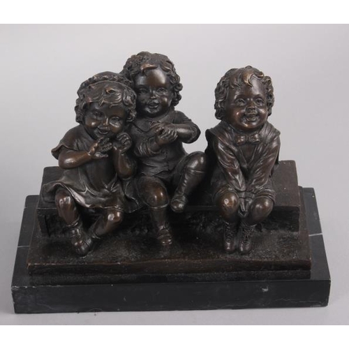 132 - Juan Clara: a bronzed figure group of three children sitting, 7