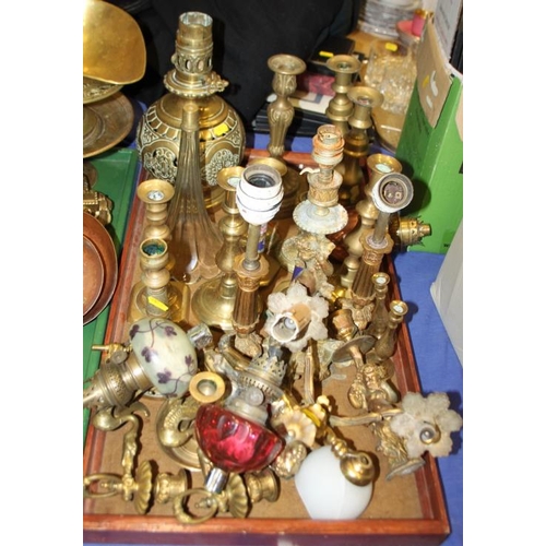 134 - A pair of enamelled brass candlesticks, oil lamps, wall lights and other items