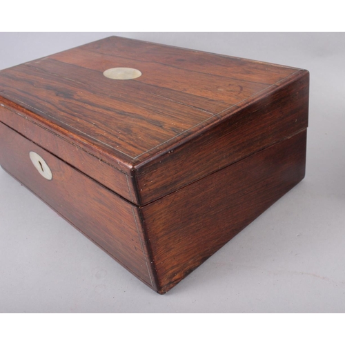 143 - A rosewood writing box with mother-of-pearl inset, 13 3/4