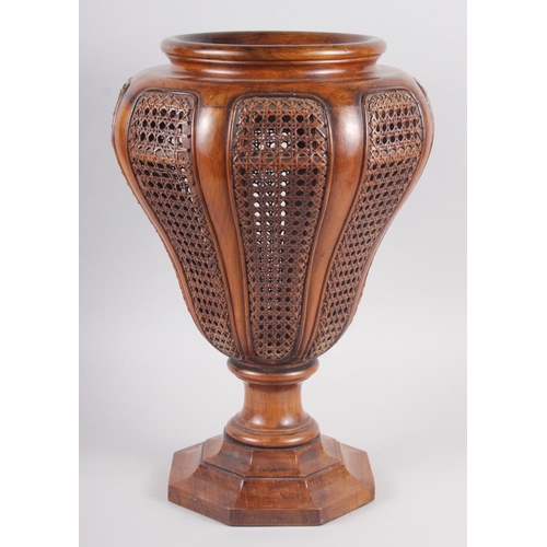 145 - A walnut and cane sided stick stand, on octagonal base, 17 3/4