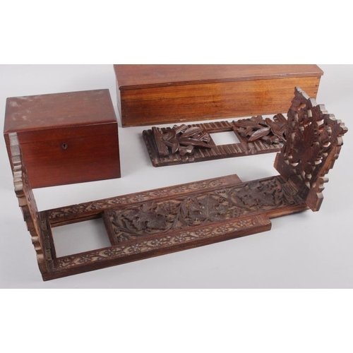 148 - An oak folding and extending book end with carved and pierced vine decoration, 16