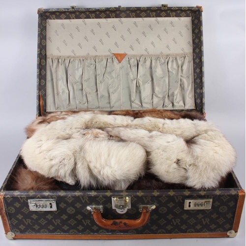 169 - A leather bound travel case and a collection of fur collars, tippets, etc